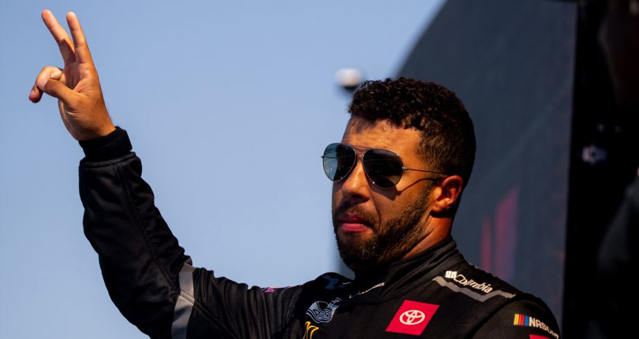 Bubba Wallace waves during driver intros at Kansas.