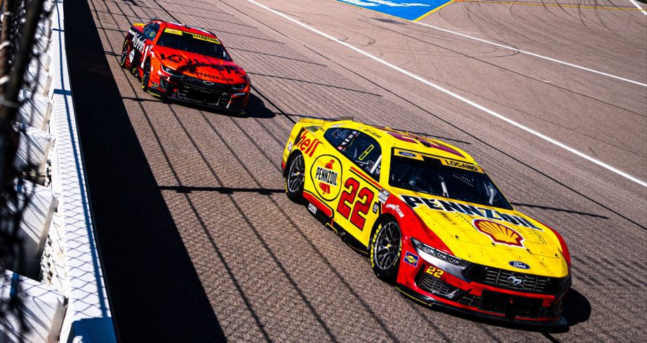 Joey Logano and Ross Chastain race at Kansas.
