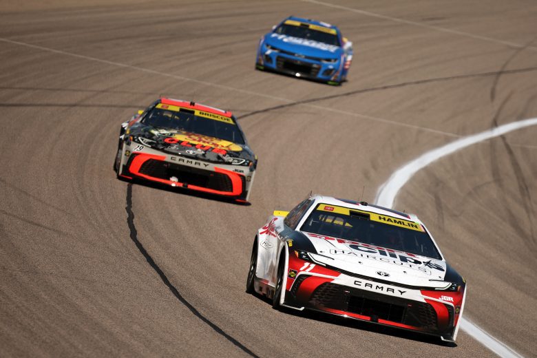 Denny Hamlin, Chase Briscoe and Kyle Larson race at Kansas.