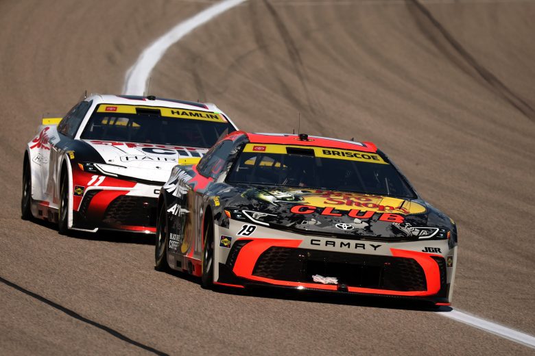 Chase Briscoe and Denny Hamlin race at Kansas.