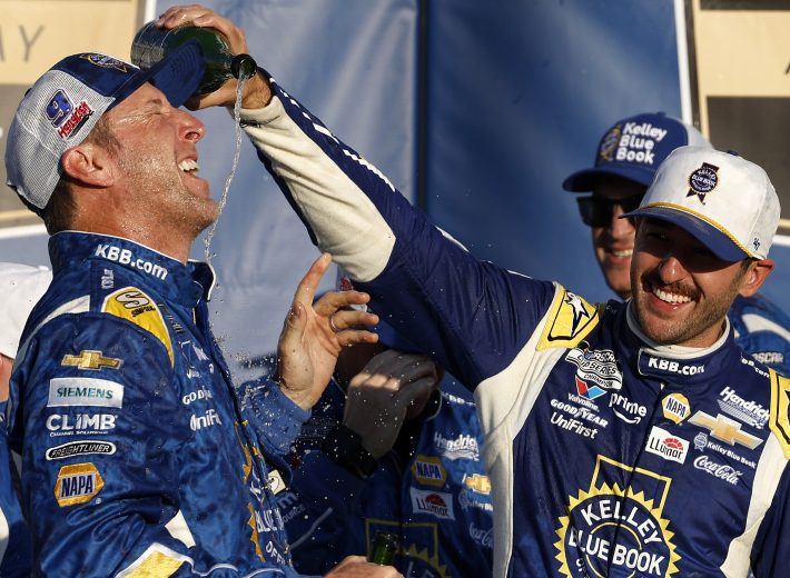 Chase Elliott pours champagne on Alan Gustafson in Kansas Victory Lane.