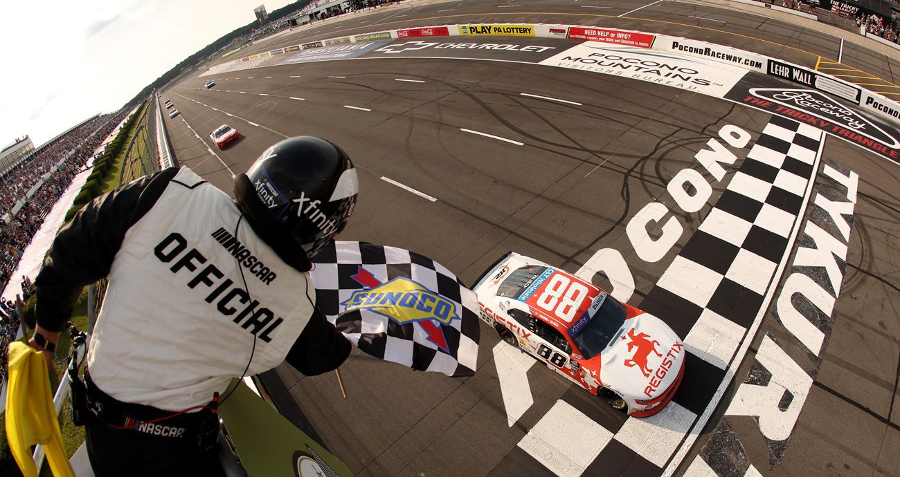 NASCAR Xfinity Series driver Connor Zilisch crosses the finish line first in 2025 at Pocono Raceway.