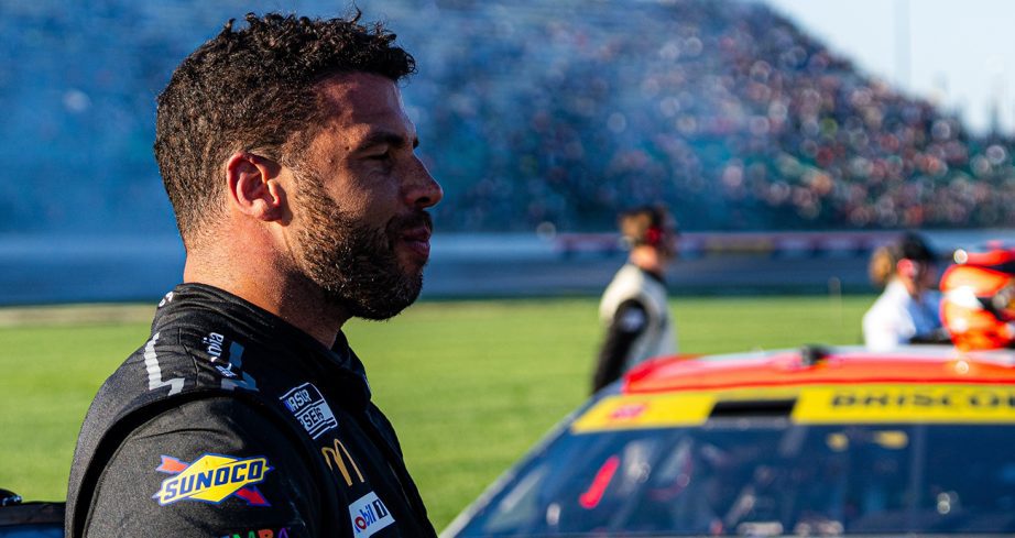 Bubba Wallace looks on.