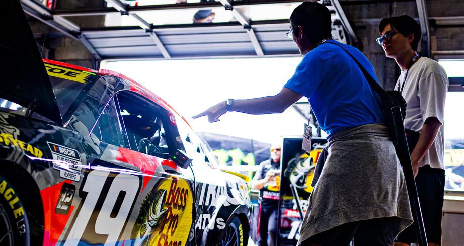 Fans look at No. 19 Toyota in the garage.
