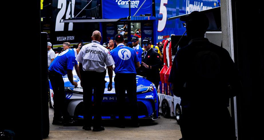 JGR crew push the No. 11 Toyota out of the garage.