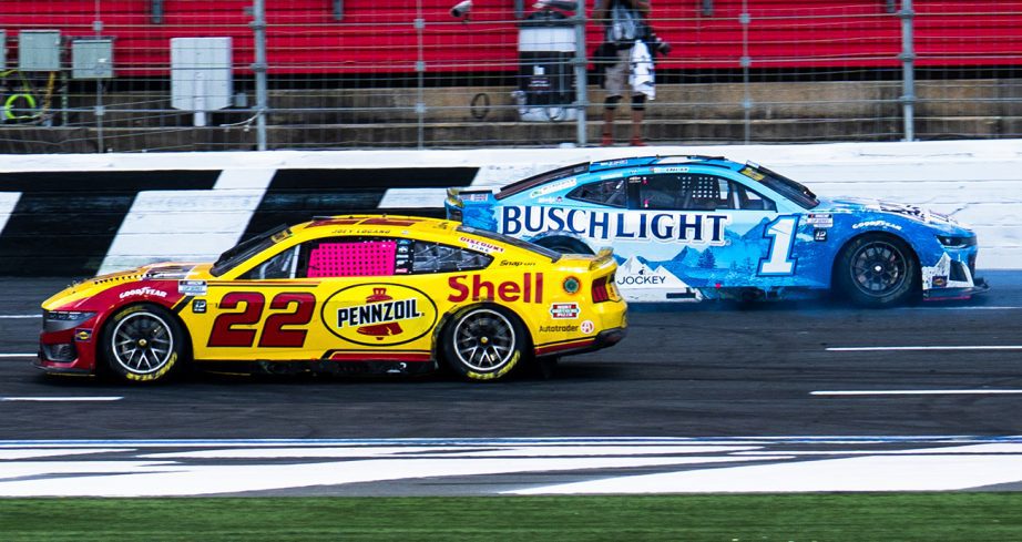 Joey Logano drives by Ross Chastain.