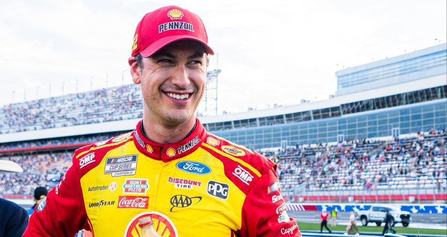 Joey Logano looks on.