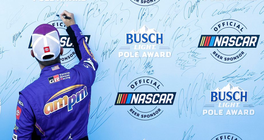 denny hamlin celebrates the nascar cup series pole at las vegas