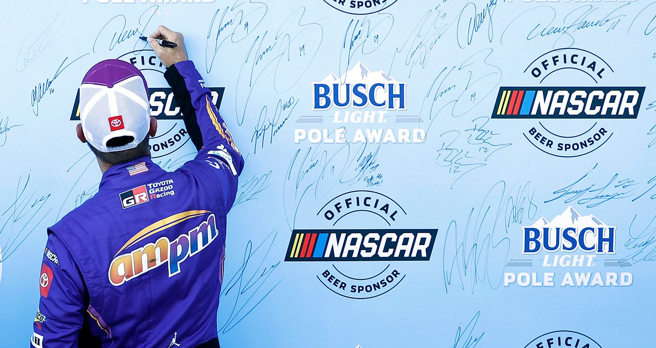 denny hamlin celebrates the nascar cup series pole at las vegas