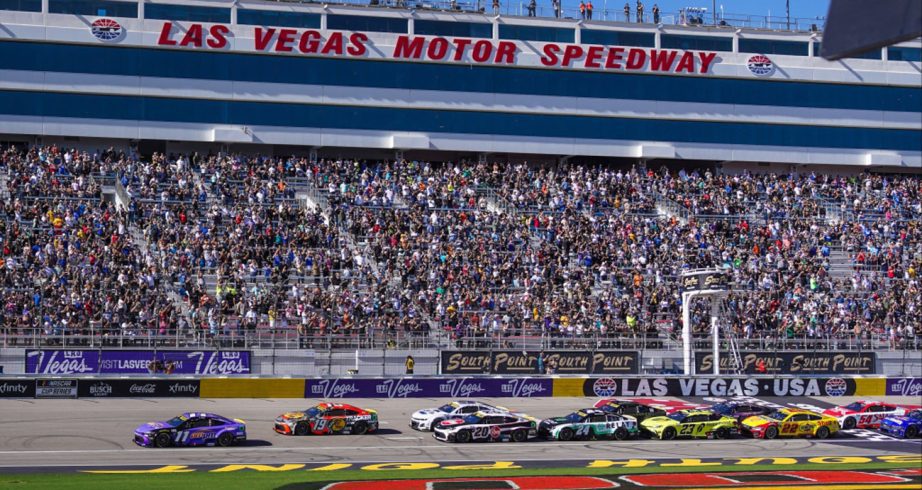 NASCAR Cup Series cars race down the frontstretch at Las Vegas Motor Speedway.
