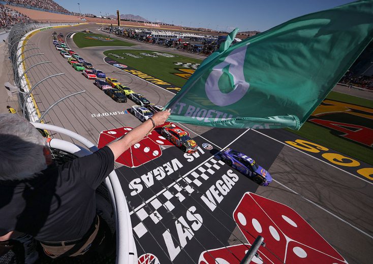 The green flag waves at Las Vegas Motor Speedway.