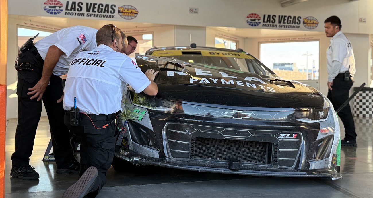 NASCAR officials check on William Byron's No. 24 Hendrick Motorsports Chevrolet in the garage at Las Vegas Motor Speedway.