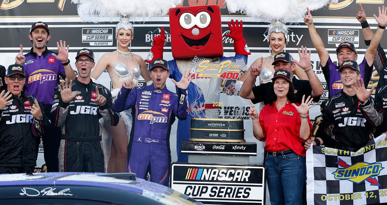 Denny Hamlin and his No. 11 Joe Gibbs Racing pit crew pose for a photo in Victory Lane at Las Vegas Motor Speedway.