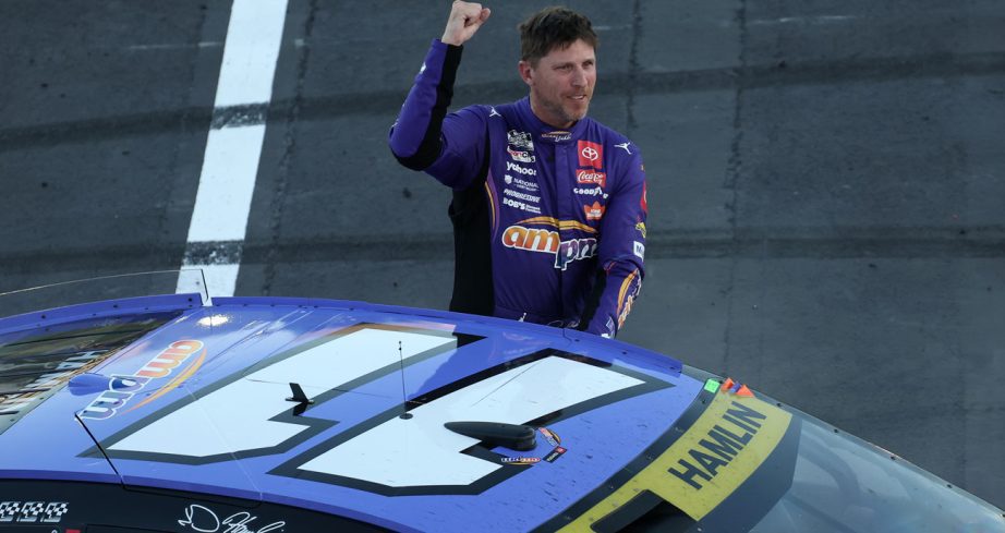Denny Hamlin raises his fist in celebration after winning the NASCAR Cup Series Playoffs Round of 8 race at Las Vegas Motor Speedway.