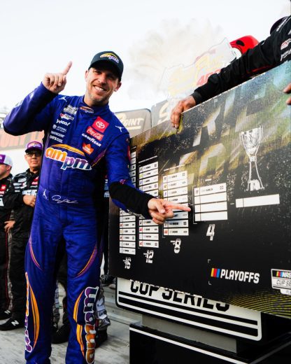 Denny Hamlin poses for a photo in Victory Lane.
