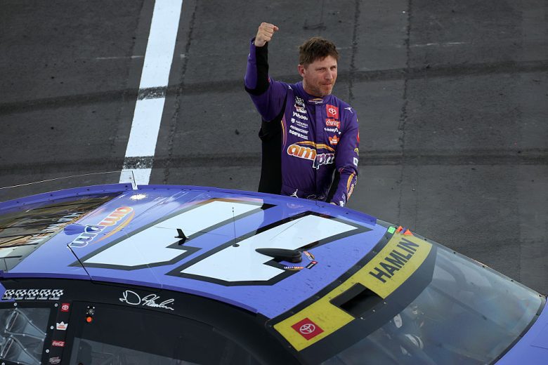 Denny Hamlin raises his fist in celebration at Las Vegas Motor Speedway.