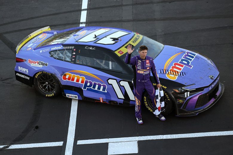 Denny Hamlin raises his fist in celebration at Las Vegas Motor Speedway.