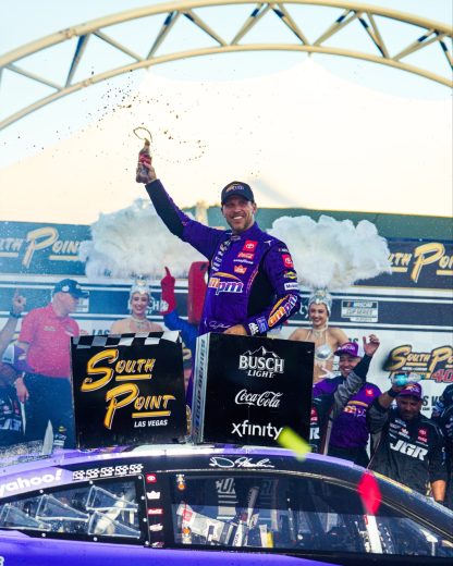 Denny Hamlin celebrates in Victory Lane.