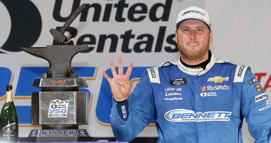 Austin Hill stands in Victory Lane at Talladega
