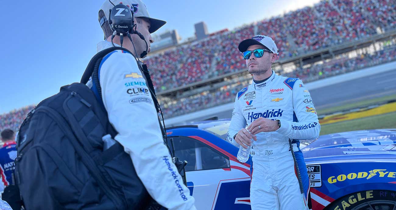 Kyle Larson, right, talks to crew chief Cliff Daniels on pit road at Talladega Superspeedway