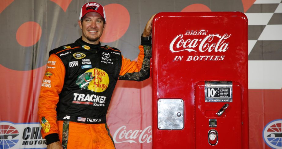 Martin Truex Jr., driver of the No. 78 Bass Pro Shops/Tracker Toyota, poses with the trophy in Victory Lane after winning the NASCAR Cup Series Coca-Cola 600 at Charlotte Motor Speedway on May 29, 2016 in Charlotte, North Carolina.