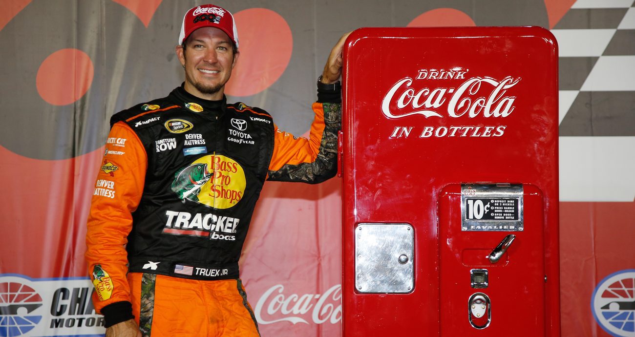 Martin Truex Jr., driver of the No. 78 Bass Pro Shops/Tracker Toyota, poses with the trophy in Victory Lane after winning the NASCAR Cup Series Coca-Cola 600 at Charlotte Motor Speedway on May 29, 2016 in Charlotte, North Carolina.