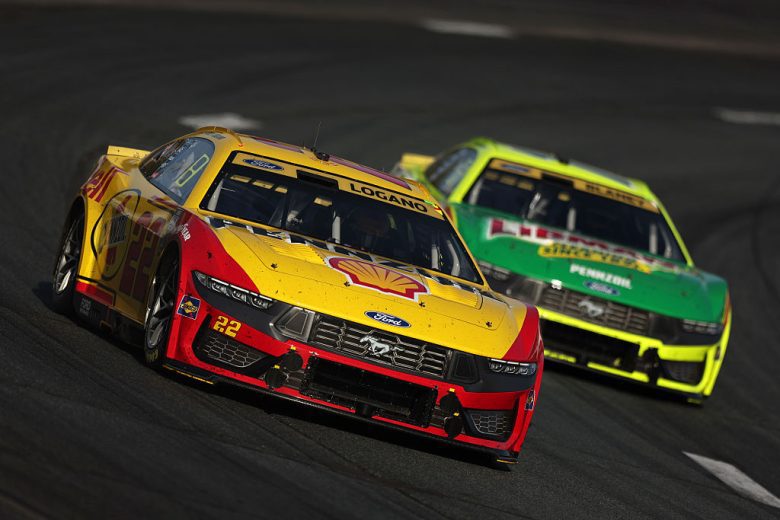 Joey Logano, in the No. 22 Team Penske Ford, races ahead of Ryan Blaney in the No. 12 Team Penske Ford during a NASCAR Cup Series race.