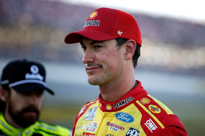 Joey Logano looks on.