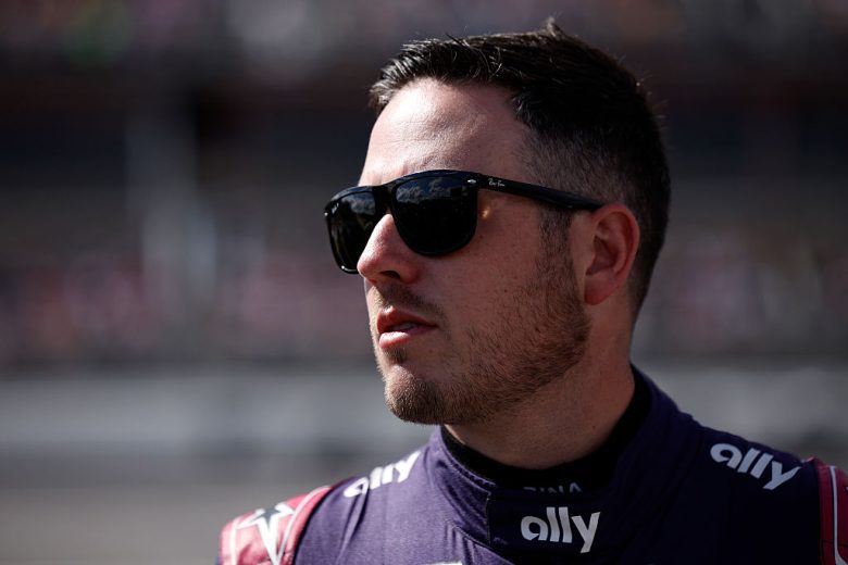 Alex Bowman looks on.