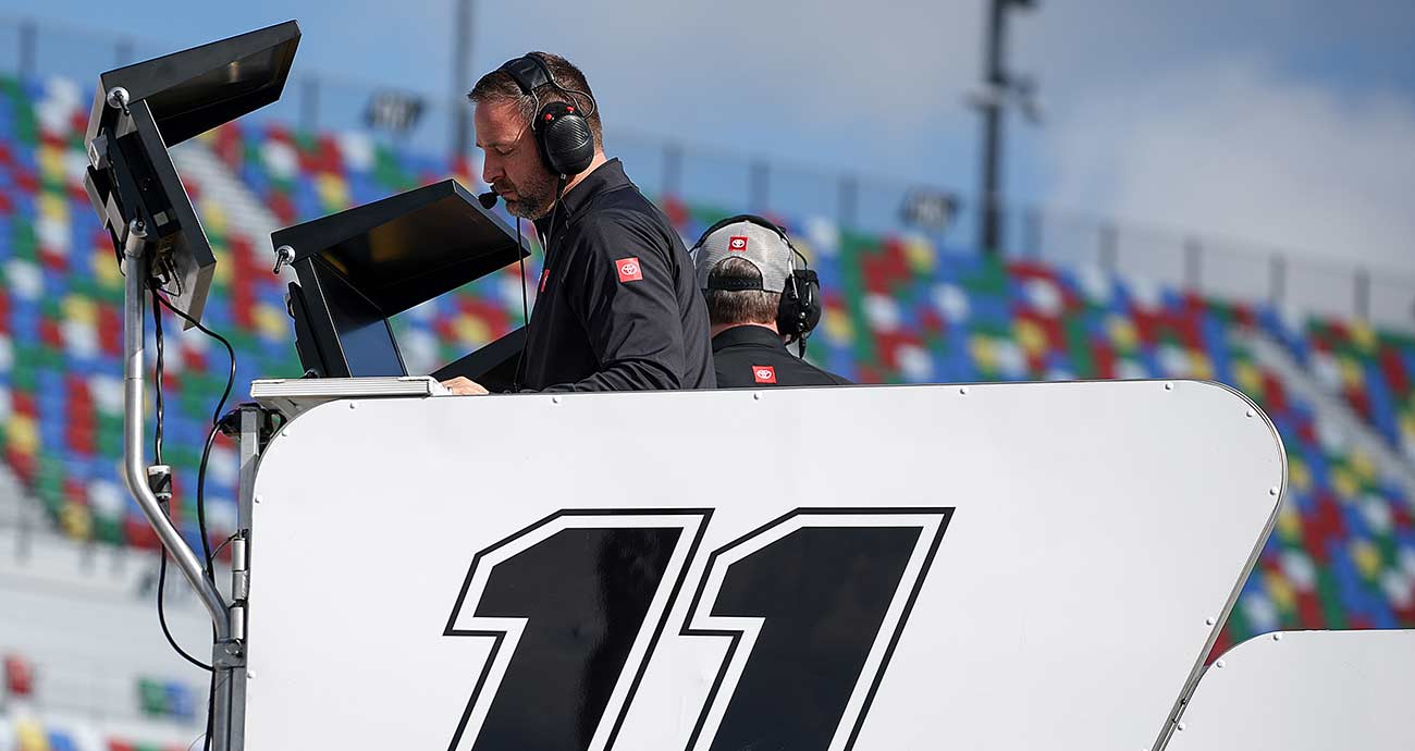Chris Gayle checks over the monitors from atop the No. 11 hauler at Daytona International Speedway