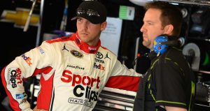 Denny Hamlin and Chris Gayle talk things over in the Xfinity Series garage at Auto Club Speedway