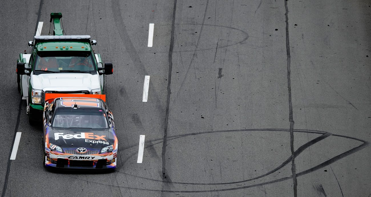 The Toyota of Denny Hamlin is pushed off of the track after an electrical problem during the NASCAR Cup Series Tums Fast Relief 500 at Martinsville Speedway on Oct. 28, 2012 in Ridgeway, Virginia.