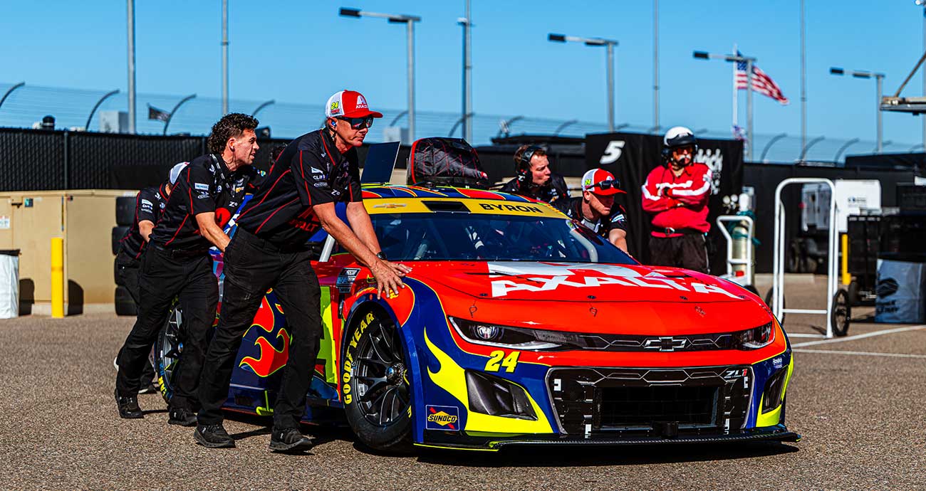 Hendrick Motorsports crew push the No. 24 Chevrolet through the Cup Series garage area at Phoenix Raceway.