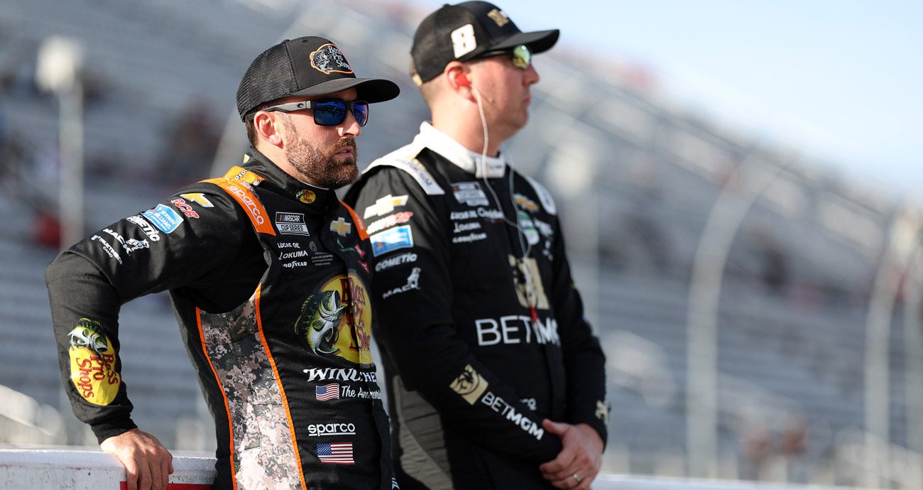 Austin Dillon and Kyle Busch look on.