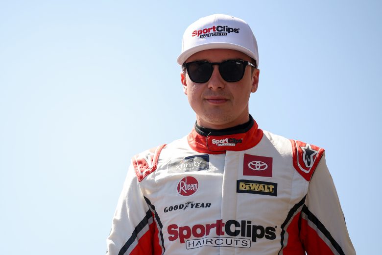 Christopher Bell looks on.