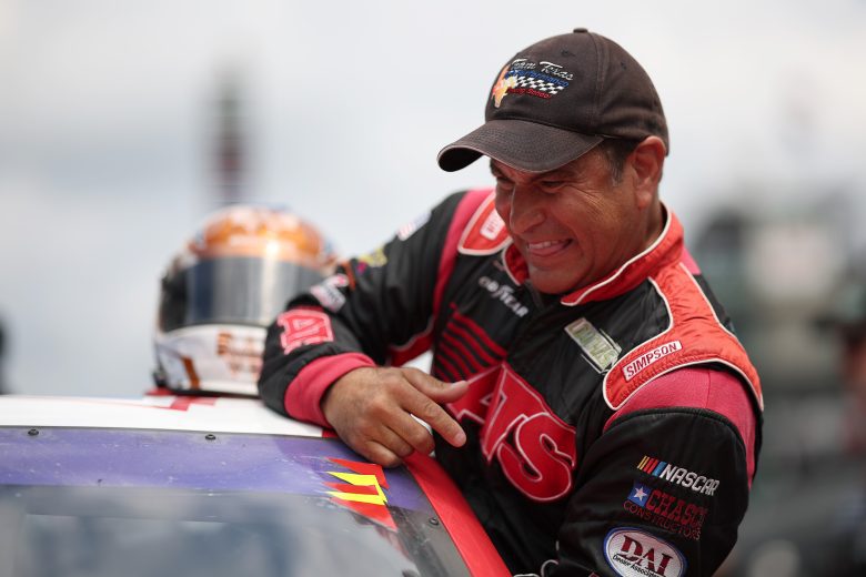 David Starr climbs into race car.