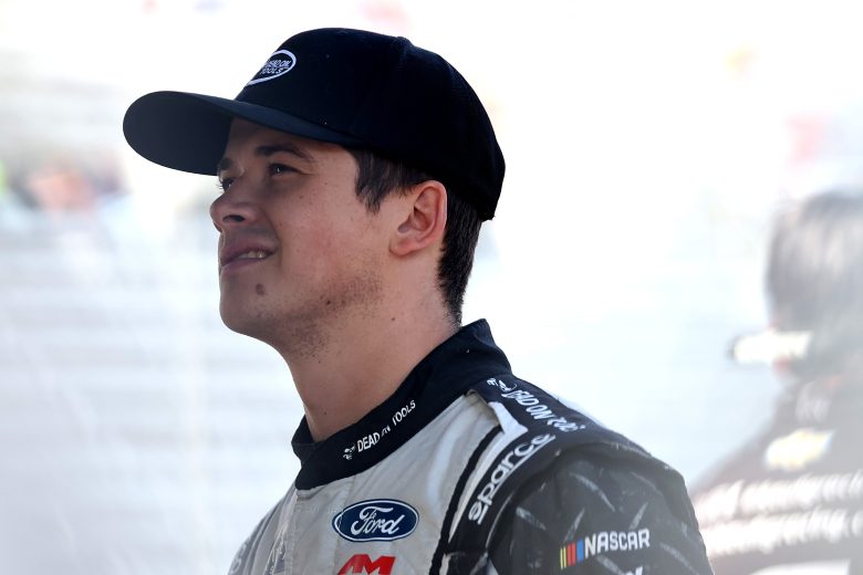 Harrison Burton looks on.