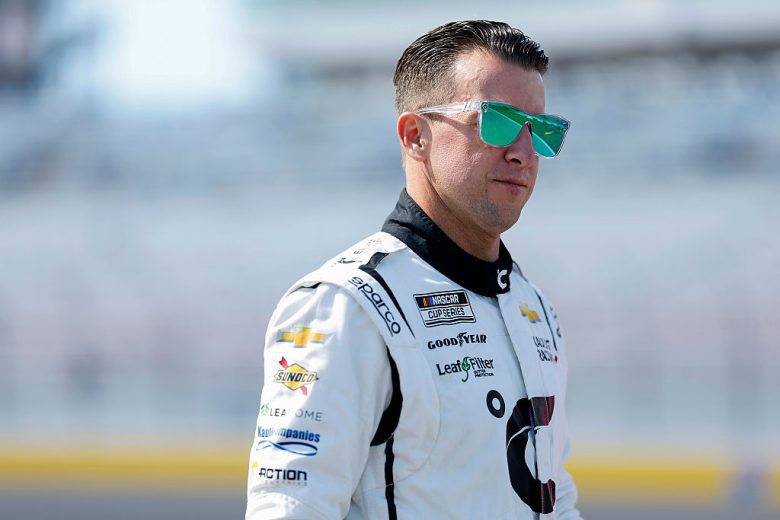 AJ Allmendinger looks on.