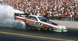 John Force's car sends smoke into the air