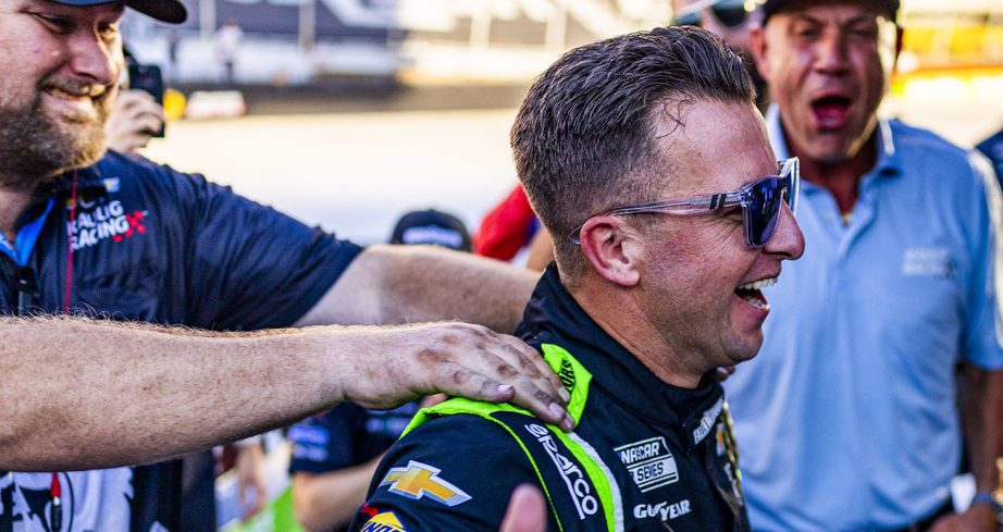 AJ Allmendinger smiles and looks on.