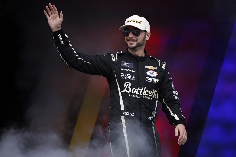 Anthony Alfredo waves to fans as he walks onstage during driver intros before the NASCAR Xfinity Series United Rentals 250 at Talladega Superspeedway on Oct. 18, 2025 in Talladega, Alabama.