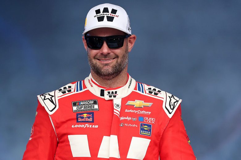 Shane van Gisbergen looks on.