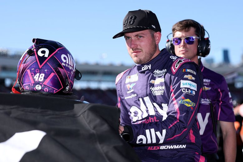 Alex Bowman looks on.