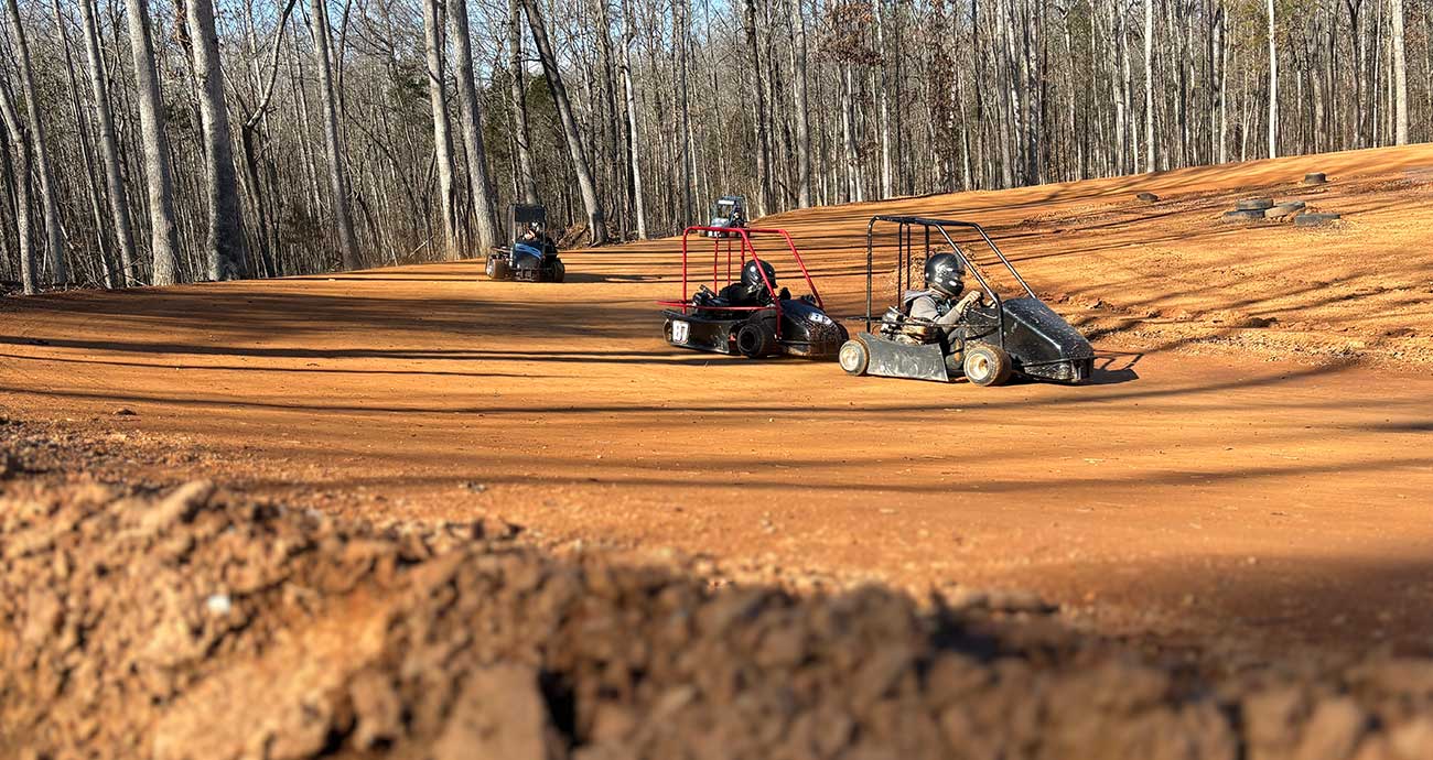 Team members race into the turns during practice runs at the Niece Motorsports dirt track