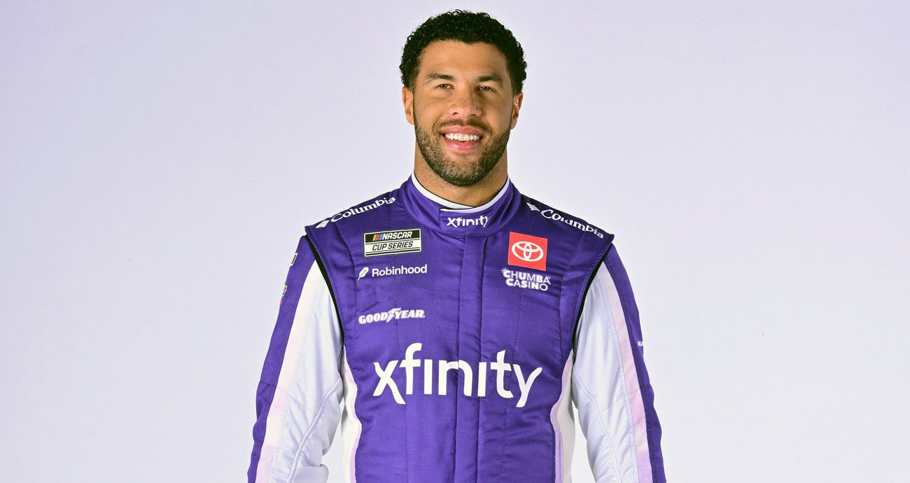 Bubba Wallace stands in his 2026 Xfinity firesuit for the NASCAR Cup Series.