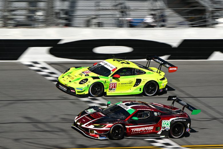The No. 023 Triarsi Competizione Ferrari and No. 911 Manthey Racing Porsche drive at Daytona.