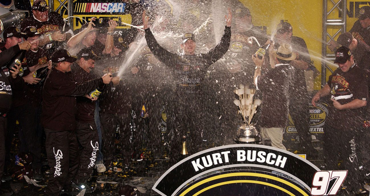 In this 2004 photo, Kurt Busch celebrates his NASCAR Cup Series championship sprayed in champagne.