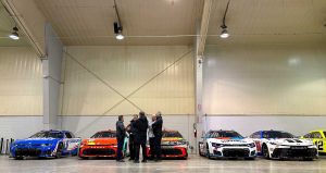 Cup Series cars line up after inspection in the Winston-Salem Fairgrounds events center