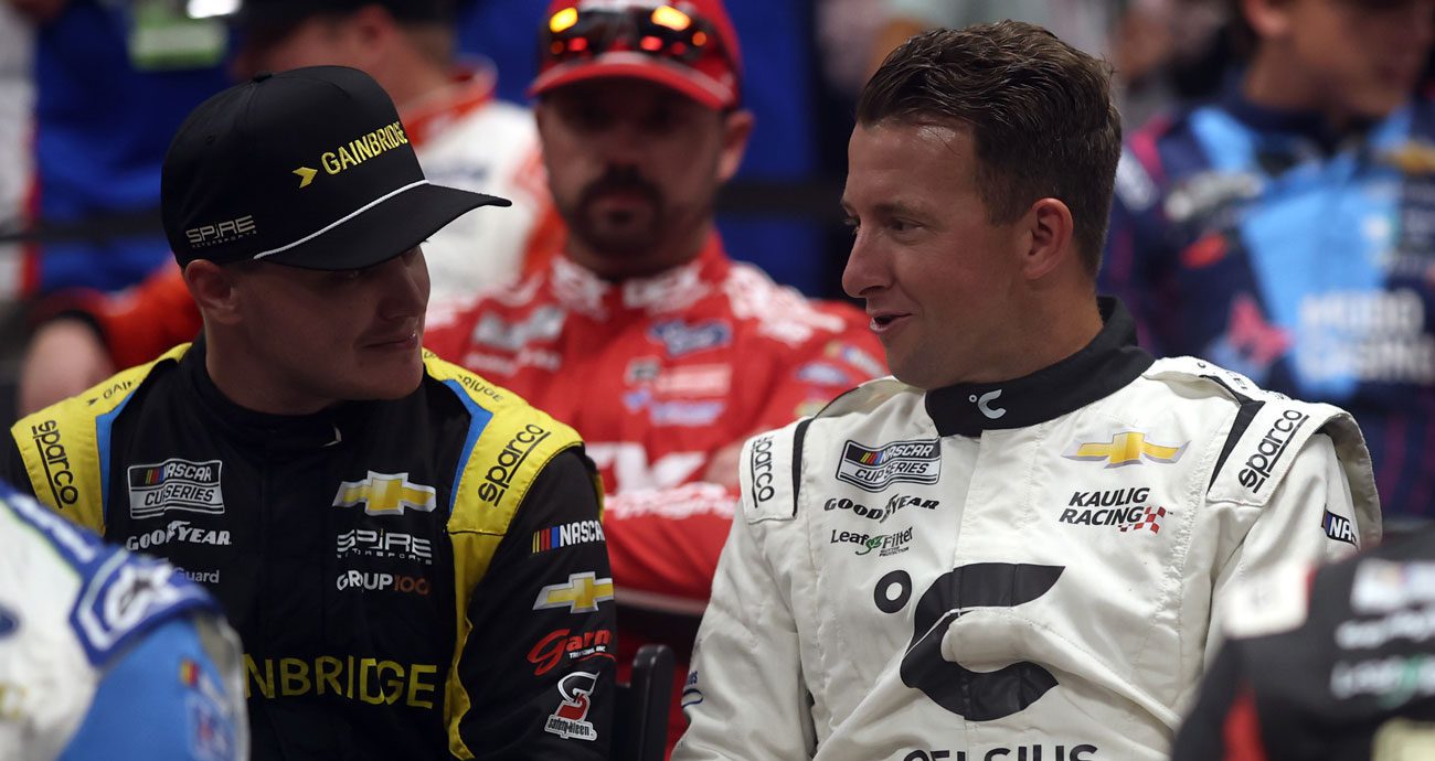 Justin Haley (L) talks with AJ Allmendinger before a NASCAR Cup Series race.