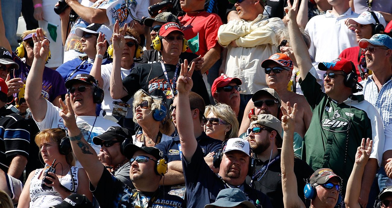 Fans salute Dale Earnhardt by holding up three fingers during the Daytona 500 in 2011 at Daytona International Speedway.